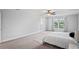Expansive main bedroom with neutral tones, ceiling fan, and large windows for a serene retreat at 3893 Burdick Loop, Odessa, FL 33556
