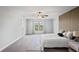 Bright and airy main bedroom features a ceiling fan, large windows, and plush carpeting at 3893 Burdick Loop, Odessa, FL 33556
