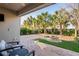 Covered patio featuring brick-paved area, fire pit, palm trees, and outdoor seating at 3893 Burdick Loop, Odessa, FL 33556