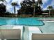 Inviting community pool with in-water lounge chairs for relaxing on a sunny day at 3893 Burdick Loop, Odessa, FL 33556