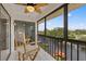Relaxing enclosed balcony with tile floors, comfortable seating, and scenic canal views at 8210 Aquila St # 227, Port Richey, FL 34668