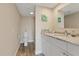 Well-lit bathroom showcasing a white vanity, decorative mirror, and walk-in shower at 8210 Aquila St # 227, Port Richey, FL 34668