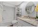 Bright bathroom featuring a tub with marble surround, granite counters, and silver fixtures at 8210 Aquila St # 227, Port Richey, FL 34668