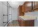 Walk-in closet featuring built-in shelving, dark wood cabinetry, and granite countertops at 8210 Aquila St # 227, Port Richey, FL 34668