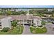 Stunning aerial view of waterfront condo complex with lush landscaping and convenient covered parking at 8210 Aquila St # 227, Port Richey, FL 34668