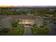 Waterfront condo complex at sunset with manicured landscaping, convenient parking, and water views at 8210 Aquila St # 227, Port Richey, FL 34668