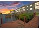 Exterior view of the condo buildings from the water, showcasing docks and vibrant sunset at 8210 Aquila St # 227, Port Richey, FL 34668