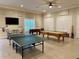 Spacious game room with ping pong table, pool table, and foosball table at 8210 Aquila St # 227, Port Richey, FL 34668