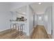 Open concept living area with breakfast bar, modern finishes, and view to the front entry at 8210 Aquila St # 227, Port Richey, FL 34668