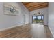 Bright living room featuring wood floors, vaulted ceilings, and access to a private balcony at 8210 Aquila St # 227, Port Richey, FL 34668