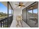 Screened-in porch with tiled flooring, a leaf-themed ceiling fan, and an expansive water view at 8210 Aquila St # 227, Port Richey, FL 34668