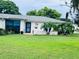 Single-story home with landscaped lawn and walkway at 8141 Bugle Ct # 1, Port Richey, FL 34668