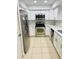 Updated kitchen, featuring stainless steel appliances and white shaker cabinets at 8141 Bugle Ct # 1, Port Richey, FL 34668