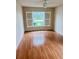 Bright bedroom featuring wood-look flooring and window shutters at 8141 Bugle Ct # 1, Port Richey, FL 34668