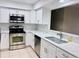 Modern kitchen with stainless steel appliances and white cabinets at 8141 Bugle Ct # 1, Port Richey, FL 34668