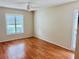 Spacious bedroom with wood-look flooring and window shutters at 8141 Bugle Ct # 1, Port Richey, FL 34668
