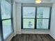 Sunroom with multiple windows, blinds and laminate flooring at 8141 Bugle Ct # 1, Port Richey, FL 34668