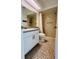Updated bathroom with a shower/tub combo and tiled floors at 8141 Bugle Ct # 1, Port Richey, FL 34668