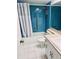 Bathroom with blue tile, a shower, and white vanity at 8141 Bugle Ct # 1, Port Richey, FL 34668