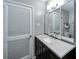 Well-lit bathroom features a stylish vanity and three-panel mirror at 6635 Stewart N Ave, St Petersburg, FL 33702