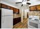 Well-lit kitchen with appliances and dark wood cabinetry, showcasing a functional and stylish cooking space at 6635 Stewart N Ave, St Petersburg, FL 33702