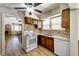 Traditional kitchen features wood cabinets, stone tile backsplash, and stainless steel appliances at 6635 Stewart N Ave, St Petersburg, FL 33702