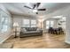 Bright living room features a gray sofa, wood-look flooring, and an arched opening to the dining area at 6635 Stewart N Ave, St Petersburg, FL 33702
