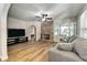 Cozy living room features a stone fireplace, comfortable seating, and an arched opening to adjacent rooms at 6635 Stewart N Ave, St Petersburg, FL 33702