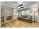 Inviting living room features a decorative stone fireplace, a gray sofa, and plenty of natural light at 6635 Stewart N Ave, St Petersburg, FL 33702