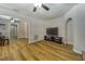 Spacious living room boasts wood-look flooring and ample space for entertaining, including a large television at 6635 Stewart N Ave, St Petersburg, FL 33702