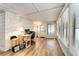 Bright sunroom with brick wall, desk and many windows for natural light at 6635 Stewart N Ave, St Petersburg, FL 33702