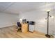 Sunroom featuring light walls and wood-look floors with dedicated office space with desk and cabinets at 6635 Stewart N Ave, St Petersburg, FL 33702
