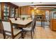 Dining room with wood table and view of fireplace at 7504 Cypress Knee Dr, Hudson, FL 34667