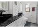 Modern bathroom featuring a granite countertop vanity and black vessel sink at 7504 Cypress Knee Dr, Hudson, FL 34667