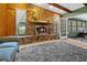 Relaxing living room centered around a large stone fireplace at 7504 Cypress Knee Dr, Hudson, FL 34667