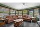 Spacious sunroom with a sectional sofa and a built-in bar area at 7504 Cypress Knee Dr, Hudson, FL 34667
