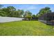 Large grassy backyard with white fence at 7504 Cypress Knee Dr, Hudson, FL 34667