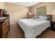 Main bedroom with dresser, large bed, and window with blinds at 7504 Cypress Knee Dr, Hudson, FL 34667