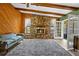 Living room features a stone fireplace and wood paneled walls at 7504 Cypress Knee Dr, Hudson, FL 34667