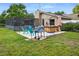 Backyard oasis with a screened patio, hot tub, and grill at 7504 Cypress Knee Dr, Hudson, FL 34667