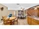 Bright dining area features a wood table with chairs, built-in hutch, and tile floor at 7504 Cypress Knee Dr, Hudson, FL 34667
