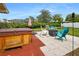 Patio with hot tub, fire pit, and rocking chairs at 7504 Cypress Knee Dr, Hudson, FL 34667