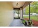 Screened-in porch with tiled floor and potted plants at 7504 Cypress Knee Dr, Hudson, FL 34667