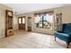 Inviting entryway with tiled floors, large window, and wooden furniture at 7504 Cypress Knee Dr, Hudson, FL 34667