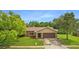 Single-story home with stone accents and a two-car garage at 7504 Cypress Knee Dr, Hudson, FL 34667