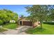 House exterior in daytime with large trees at 7504 Cypress Knee Dr, Hudson, FL 34667