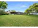 Large backyard with lush grass and screened patio at 7504 Cypress Knee Dr, Hudson, FL 34667