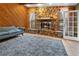 Living room with stone fireplace and wood walls at 7504 Cypress Knee Dr, Hudson, FL 34667