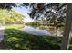 Serene pond reflecting the surrounding trees and sky in a peaceful park setting at 6642 Stewart N Ave, St Petersburg, FL 33702