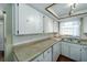 Bright kitchen with white cabinets, granite countertops, and modern appliances at 6642 Stewart N Ave, St Petersburg, FL 33702